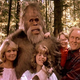 Screenshot: Harry And The Hendersons. In this 1987 film, a small boy is devoured by his enormous glasses. Lithgow appears well aware that this is not his finest work.